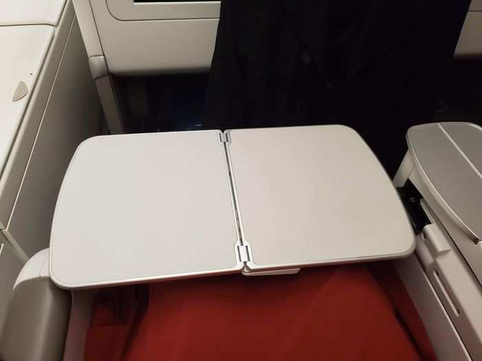 I was kind of bummed by how small the tray was, and that it was the kind that came out of the armrest. But the flight attendants put a tablecloth over each one for meal service, which classed it up.