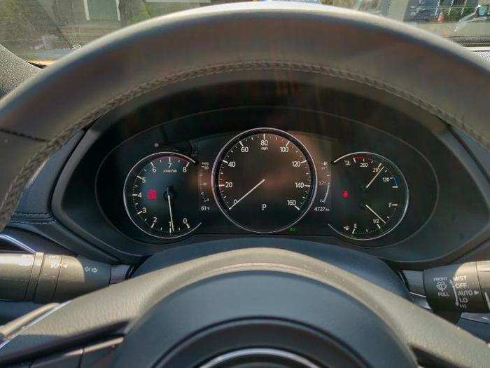In front of the driver is a central digital-information display flanked by a pair of analog gauges. The digital display is engineered to mimic a traditional analog gauge.