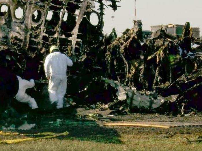 On Monday, investigators began working their way through the charred remains of the jetliner.