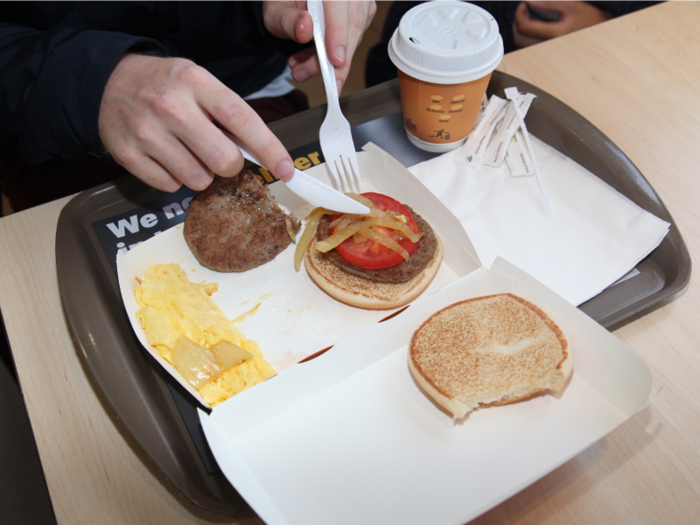 The bun made us think a sandwich was the way this meal was intended to be eaten. So we stacked the single tomato and a few onions on top of a patty ...