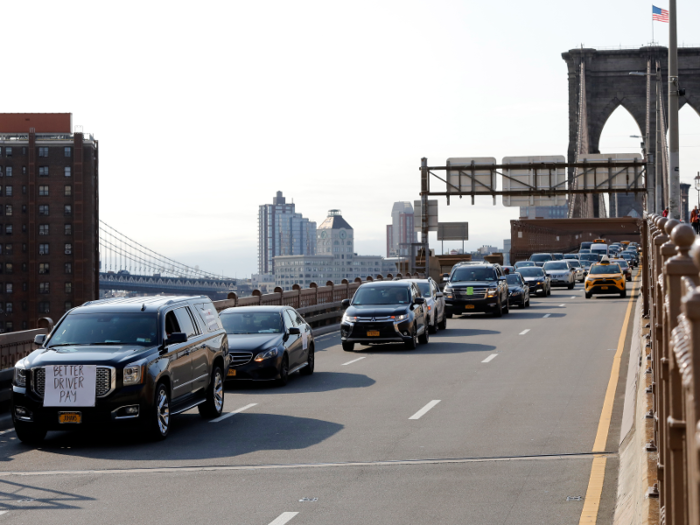 In New York, a caravan of Uber and Lyft drivers arrived across the Brooklyn Bridge.