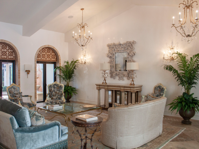 The inside of the home is opulently decorated with high ceilings and chandeliers.