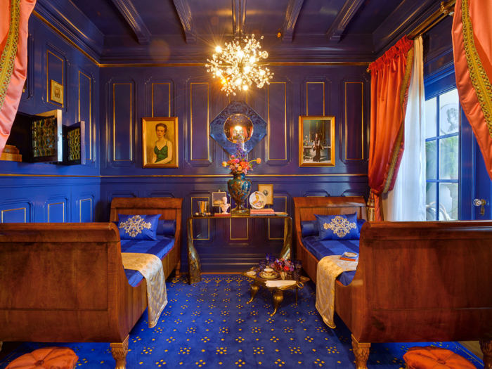 Off to the side of the room is an intimate lounging area in a royal blue and gold alcove.