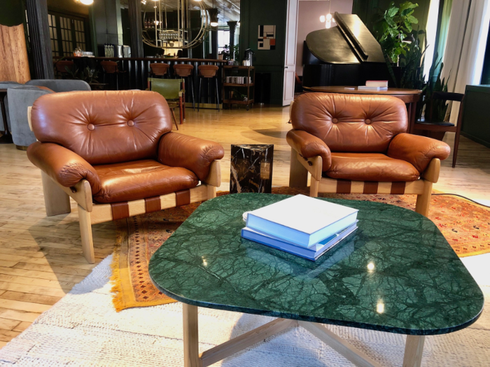 Brown leather armchairs brought in clubhouse vibes — they were some of the softest chairs I had ever sat in.