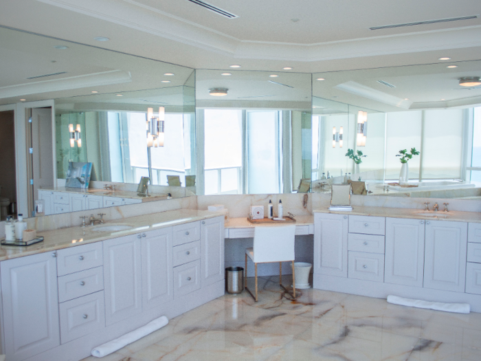 I stepped into the master bathroom, which features marble floors, double vanities, and large mirrors that reflect the Florida sunshine.