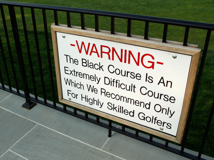 A sign warns the players that casual golfers might be better off finding a different course.