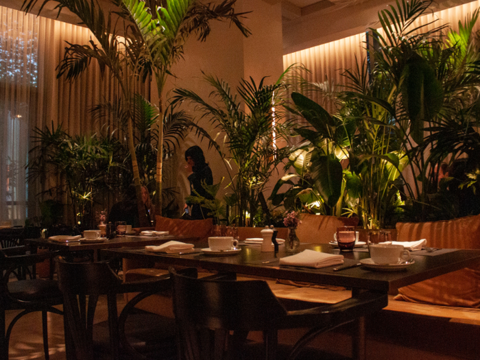 The dimly lit eatery is full of live plants, giving a jungle-like effect.