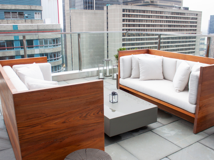 The terrace includes two stylish outdoor sofas and a sound system.