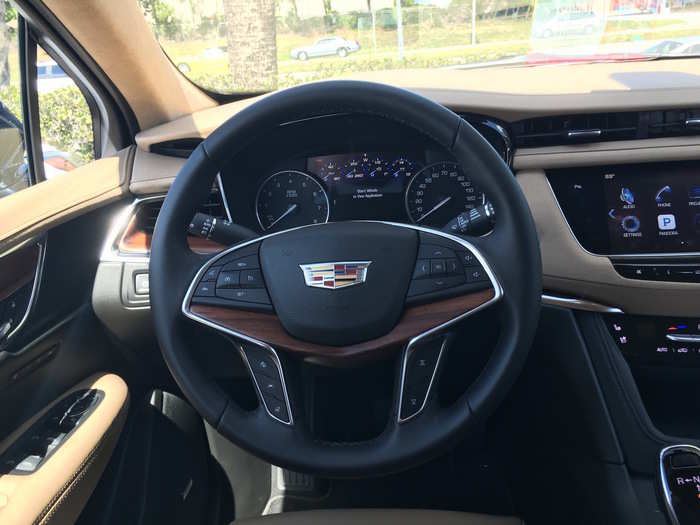 The instrument panel is sort of old-school, but the steering wheel — leather-wrapped and wood-trimmed — is thoroughly modern, with buttons to control just about every function on the XT5.
