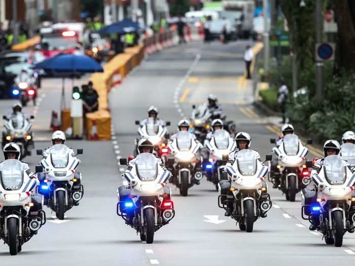 Local law enforcement provides another layer for the motorcade on the way to the official