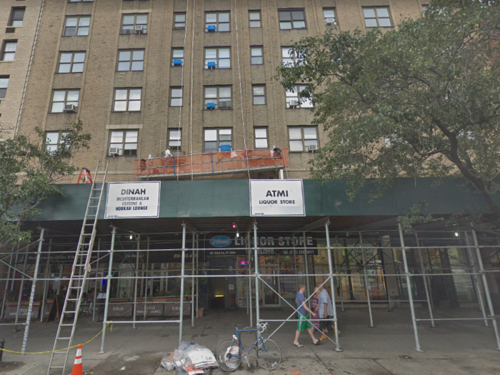 The street level of the building is occupied by a liquor store and a Mediterranean restaurant and hookah lounge, according to Google Maps.