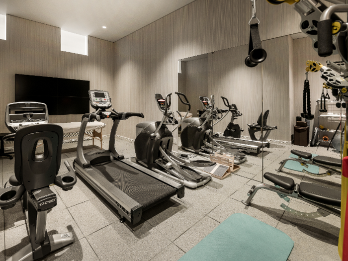 On the lower level of the condo is a large private gym, as well as an en suite guest room, a recreation room, and a laundry room.