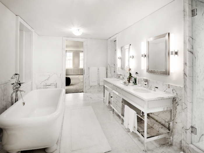 The master bathroom is outfitted almost entirely in white marble.