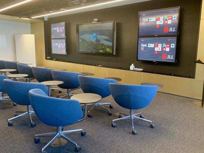 "The Lab" is a conference room with rolling desks that can be configured into smaller "pods" for group work, and an audio/visual system that connects multiple offices.