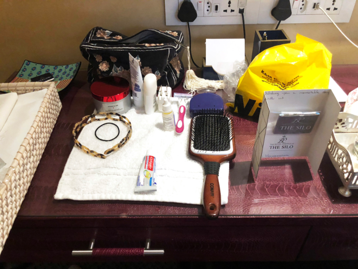 ... and they had even straightened up our clothes. They arranged all the grooming accessories my friend had left out onto a towel on her desk. Even her retainer case was lined up perfectly above her hairbrush — the staff