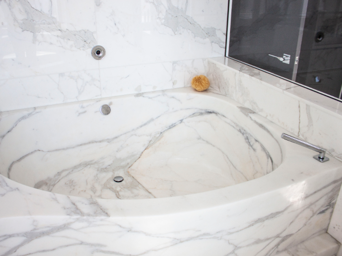 The custom Waterworks Belvedere air-jet soaking tub is carved from a single chunk of marble.