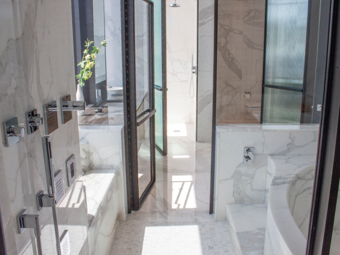 The master bathroom, which is outfitted with Italian marble, comes with dual vanities and steamed showers. The glass-enclosed wet room can turn into a steam room.