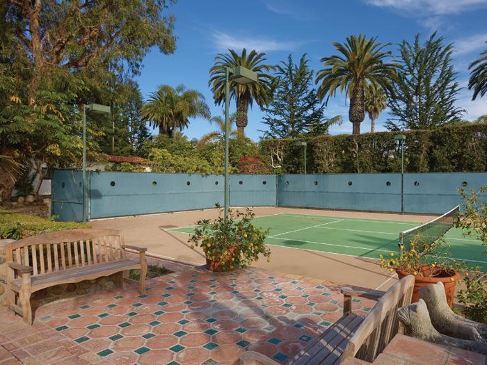 The grounds also include a tennis court with nearby patio space ...