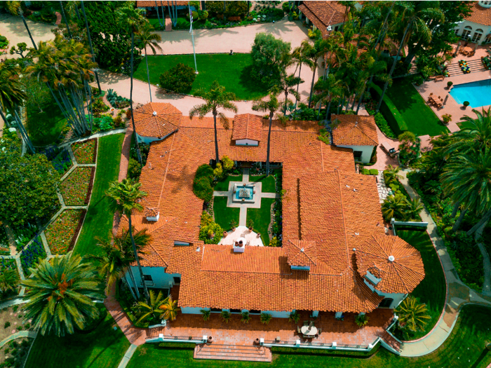 The main house was constructed in 1927; its architectural is described as "Spanish Colonial Revival." The square building encloses a courtyard in its center.