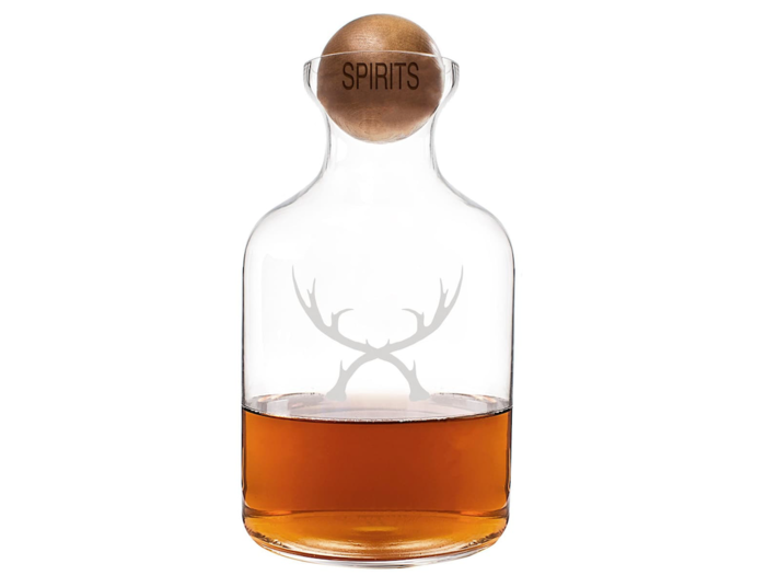 A glass decanter with a cool wood stopper