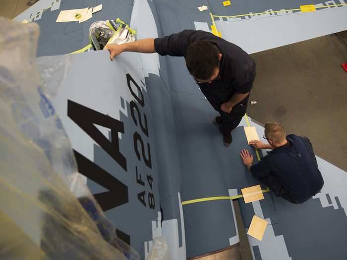 From there they had to mask, sand, wash, prime, paint and apply stencils to the aircraft for it to be completed.