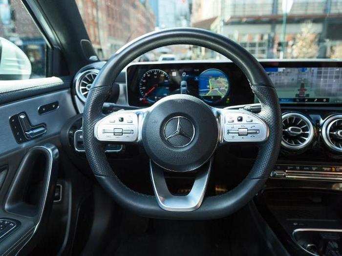 The leather-wrapped steering wheel is outfitted with the usual batch of buttons, thumbwheels, and switches, controlling many vehicle functions and enabling the driver to keep those hands on the wheel.