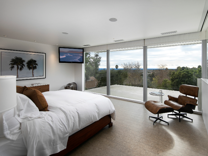 This bedroom overlooks lush landscaping.