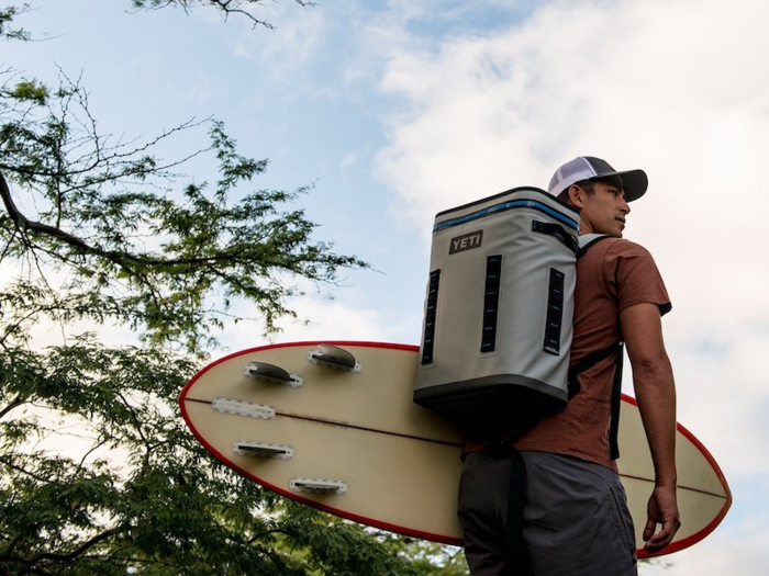 A soft-sided cooler backpack.