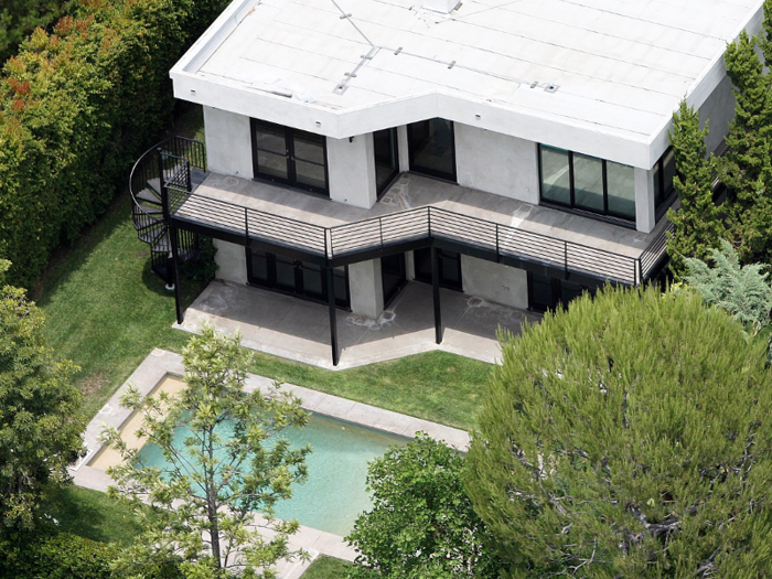 The home has an in-ground swimming pool and a second-floor, wrap-around deck.