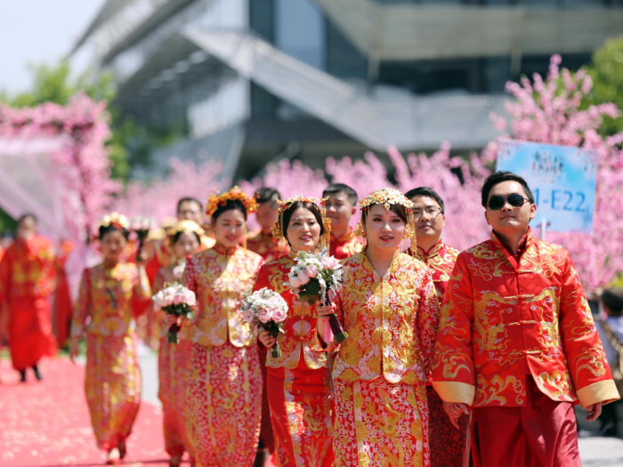 They walk down a red carpet to the ceremony.