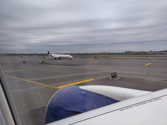 As we taxi to the runway, we pass a Bombardier regional jet. Delta still operates CRJ900 regional jets on flights between New York and Dallas.