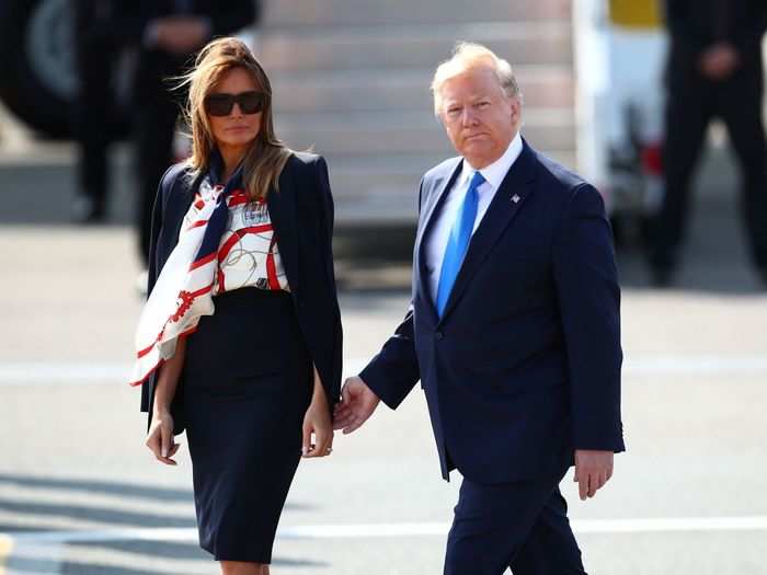 The first lady sported an eye-catching Burberry blouse for her British arrival.