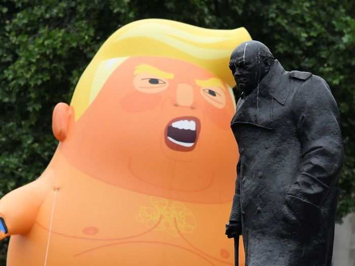 The balloon was in good company with another towering political figure in Parliament Square as it appeared by former Prime Minister Winston Churchill