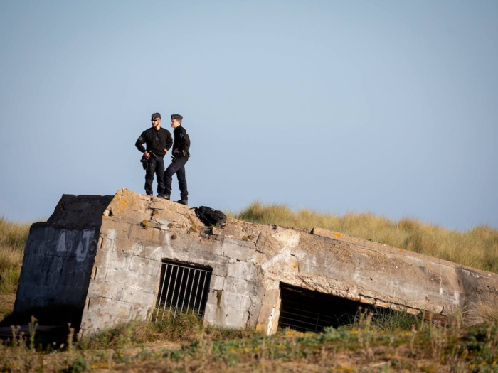 French policemen stood on top of an old bunker to watch over D-Day commemorations at Juno Beach in Normandy.