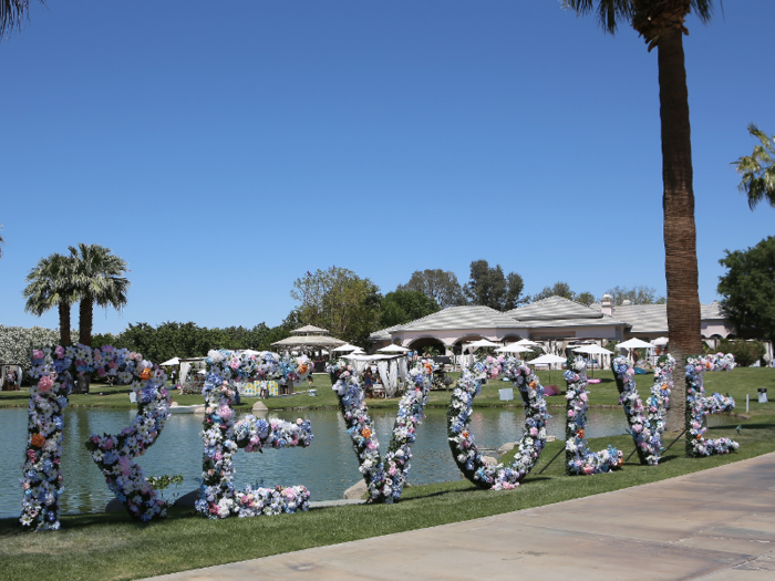 The experience typically includes cabanas and decor like this sign made of flowers.