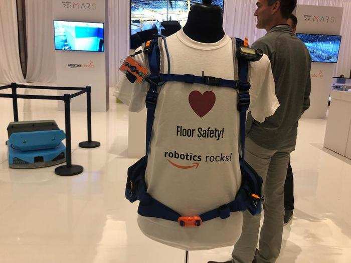 Using robots in warehouses lets Amazon stack inventory shelving closer together and higher, packing more inventory into every warehouse. Human workers wear these vests that help the robots to "see" them and stay safely out of a human