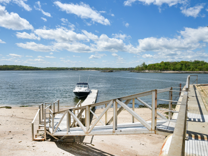 The home comes with a boat and a barge.