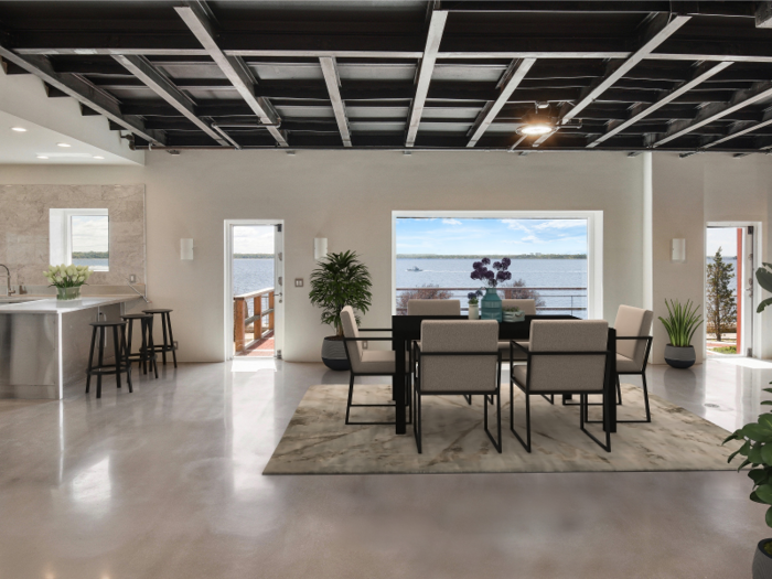 A rendered image of the dining room shows what the open-kitchen area could look like furnished ...