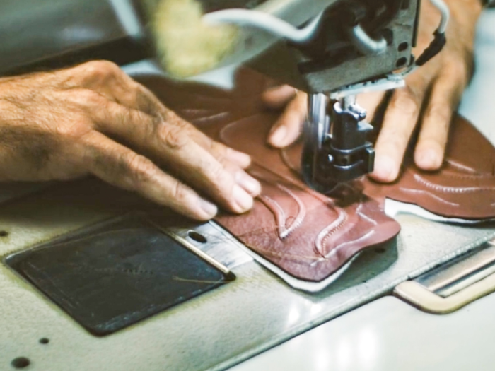 That includes the cutting of leathers, laying the cording on by hand, hand-stitching on the shaft — or the top part of a cowboy boot — and painting.
