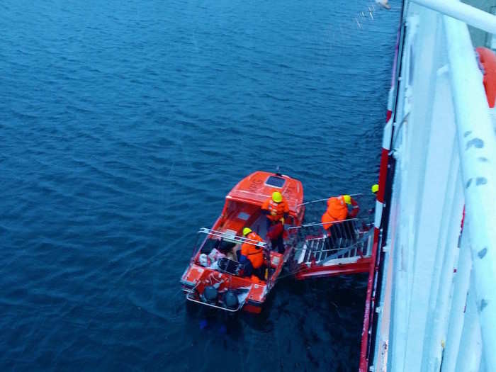 We were unable to dock in Kangaamiut, so passengers and cargo had to be transported to shore on a small orange motorboat.