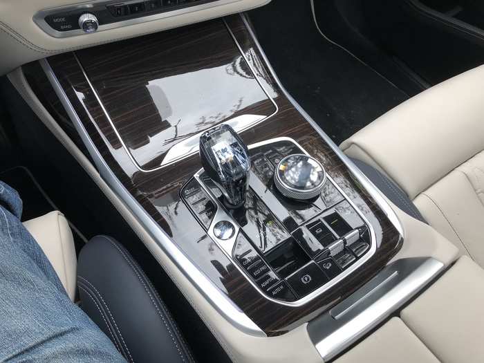 The center console consolidates the crystal joystick shifter, drive-mode selector, and the knob and buttons for the iDrive infotainment system.