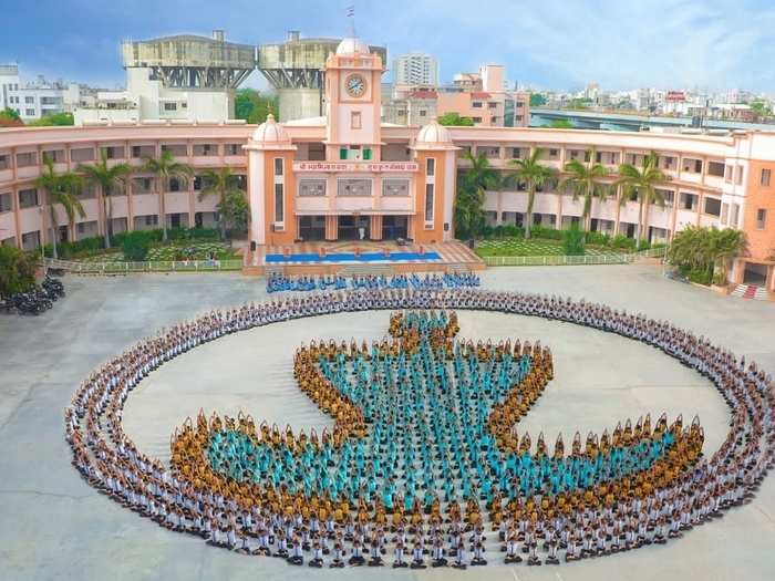 People celebrating yoga day by forming a unique symbol of Buddha