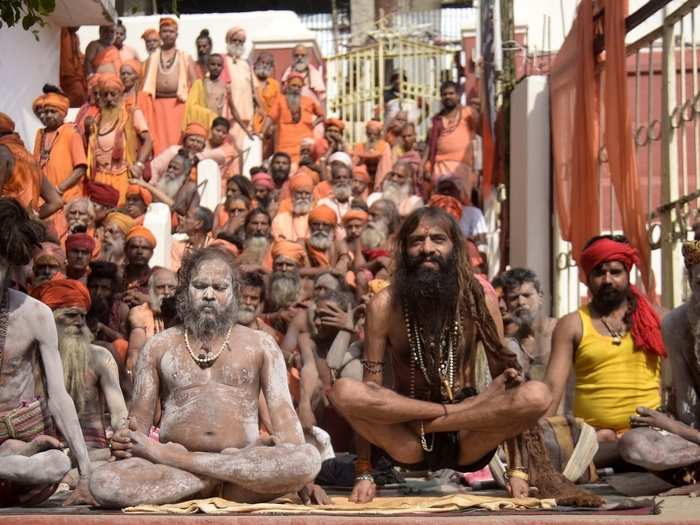 Several Naga sadhus and other devotees perform yoga at the ancient Kamakhya temple at an event organised to mark the Yoga Day.