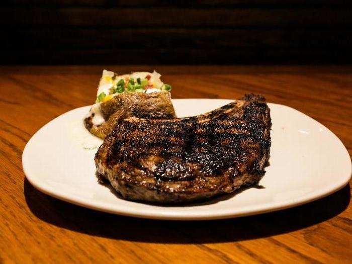 For my main course, I ordered a bone-in ribeye with a loaded baked potato side and mixed vegetables at both restaurants.