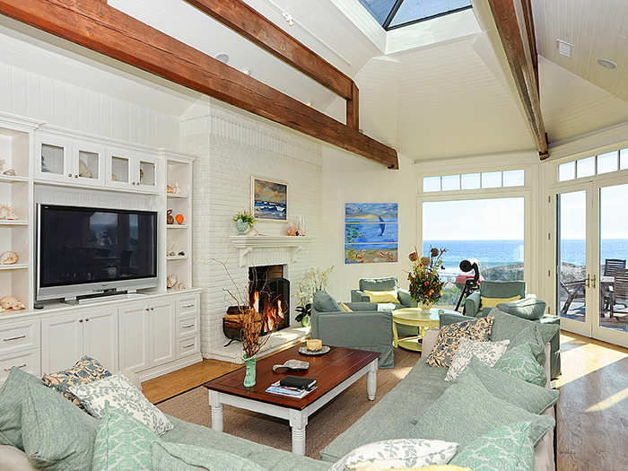 The living space has skylights and floor-to-ceiling windows that look out onto the Pacific Ocean.