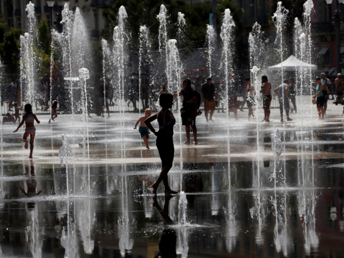 Elsewhere in France, people are using fountains to keep cool, like these folks in Nice.