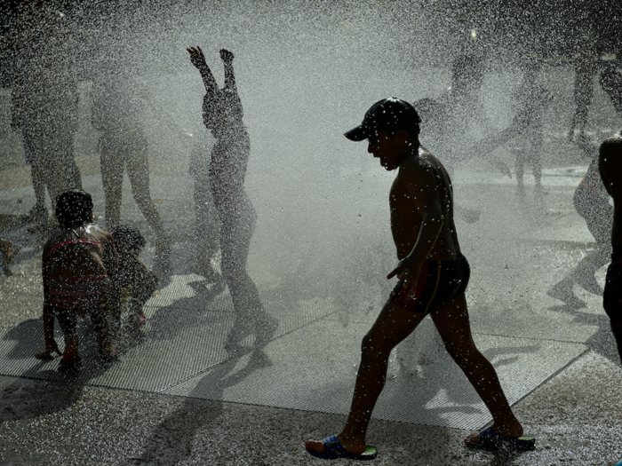 In Spain, where temperatures are expected to rise above 36 C (95 F), many people took advantage of public fountains.