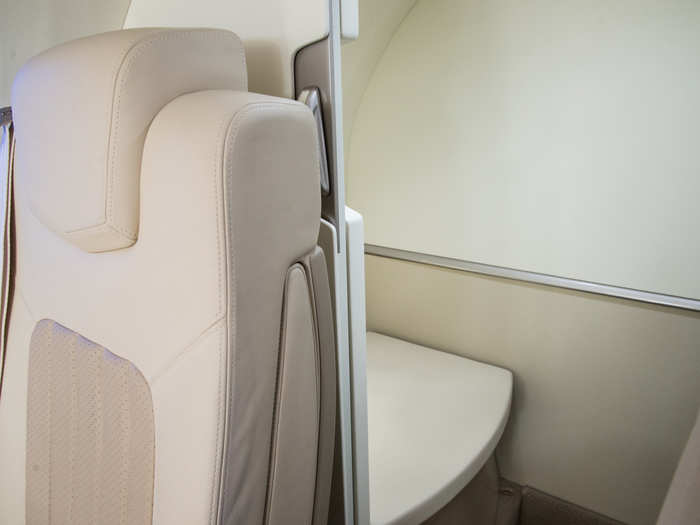 There is a bathroom at the back behind a sliding door, and you can even belt yourself into the toilet. Many small private jets do not have toilets, so this is a major perk for the HondaJet.