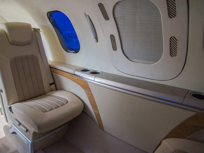 There is a generous amount of space between the seats, and each seat has its own window (which was tinted blue at the Paris Air Show, but can also be clear glass). You can also pull a table out of the armrest area under the window.