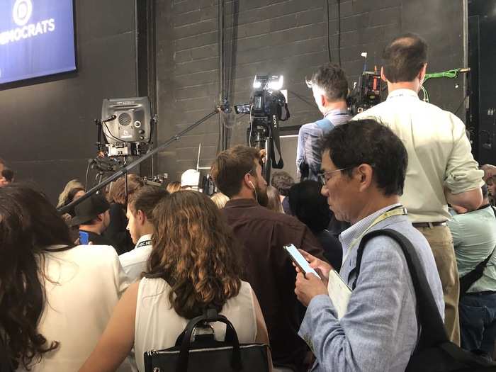 All of the candidates entered the Spin Room through the same door, which was blocked off by both a physical barrier and a wall of camera people. If you wanted to get close, you had to try and squeeze in or box people out. Some people resorted to standing on chairs just to get a look.